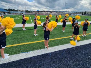 BYFL cheerleaders with yellow pompoms during game